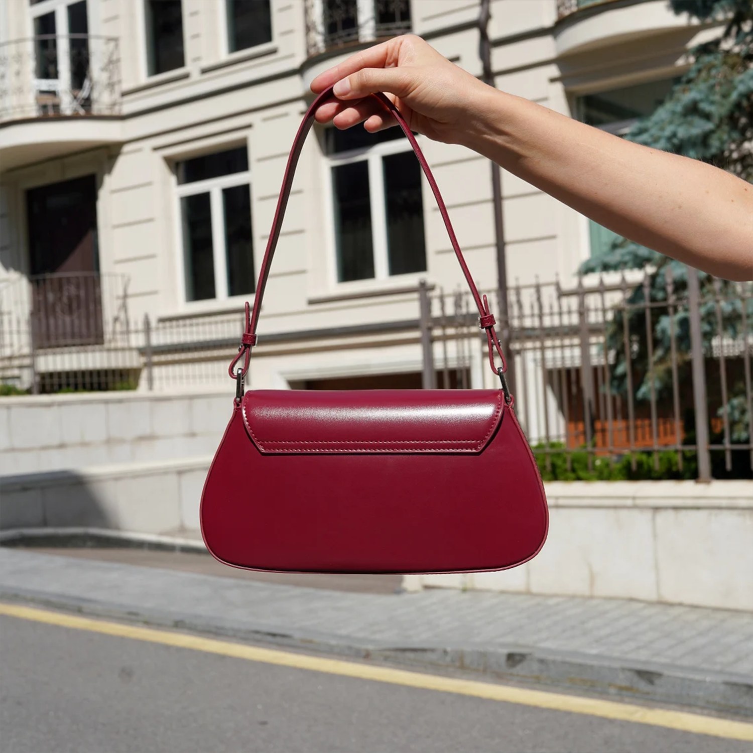 Glossy Deep Scarlet Curved Baguette Shoulder Pouch With Adjustable Matching Shoulder Strap And Overlapping Stitched Front Flap