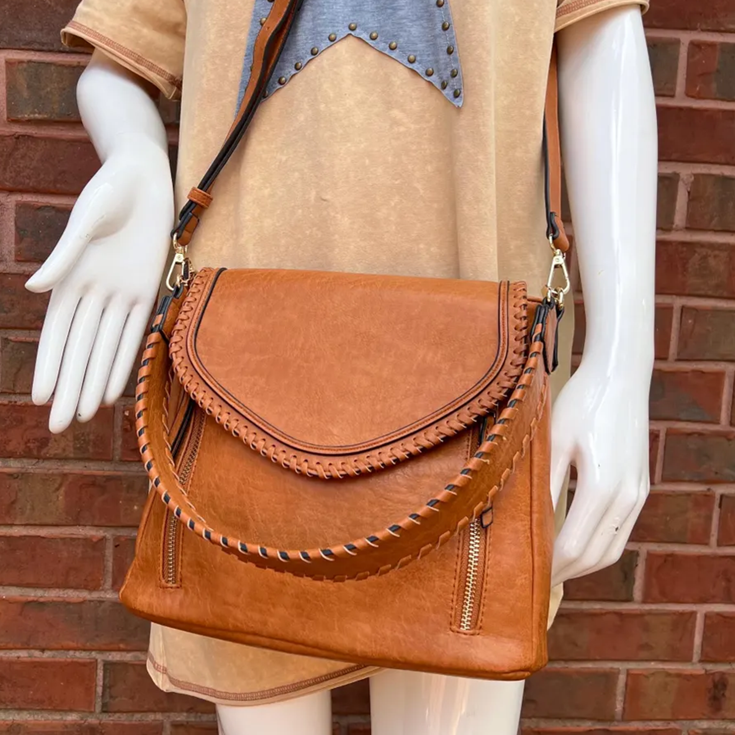 Warm Tan Whip-Stitched Curved Flap Shoulder Bag With Integrated Top Grip, Adjustable Hanging Band And Dual External Zip Storage Slots