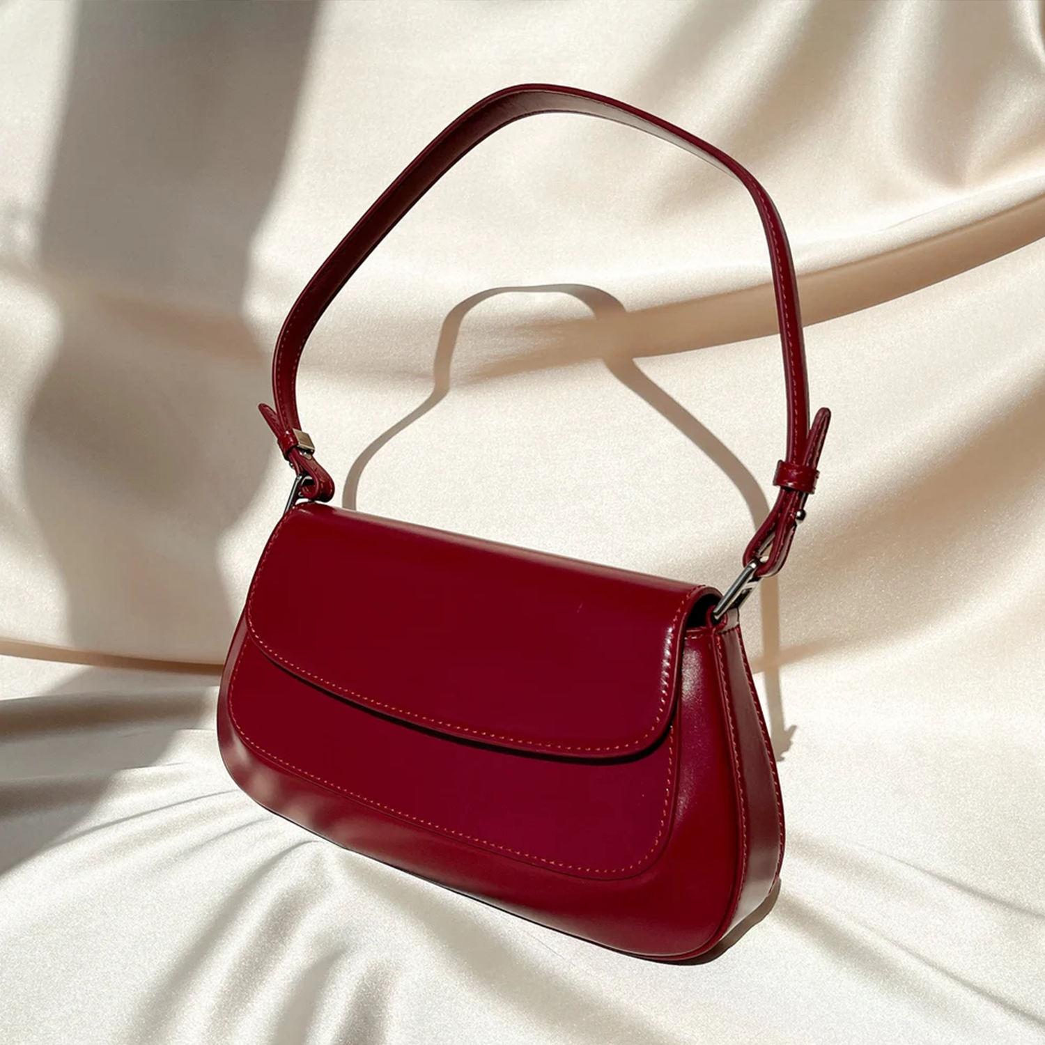 Glossy Deep Scarlet Curved Baguette Shoulder Pouch With Adjustable Matching Shoulder Strap And Overlapping Stitched Front Flap